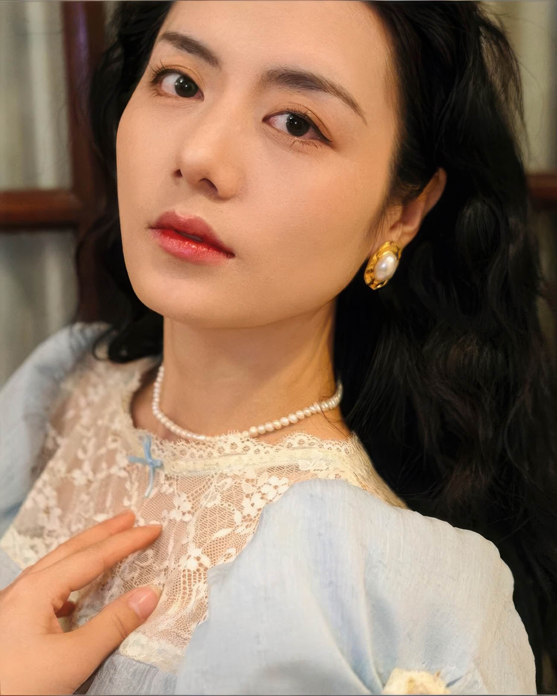 Model wearing the vintage-style oval pearl earrings, showcasing their elegant large-scale design.
