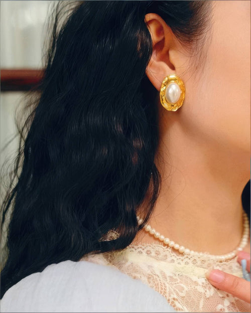 Close-up of the Radiant 18K gold plated pearl studs on a model, highlighting the classic pearl luster.