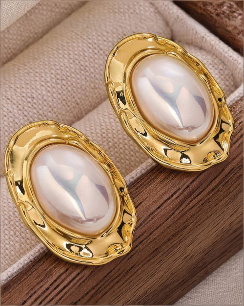 Pair of oval Mabe pearl earrings in 18K gold plating, captured in natural light for a soft, luxurious glow.