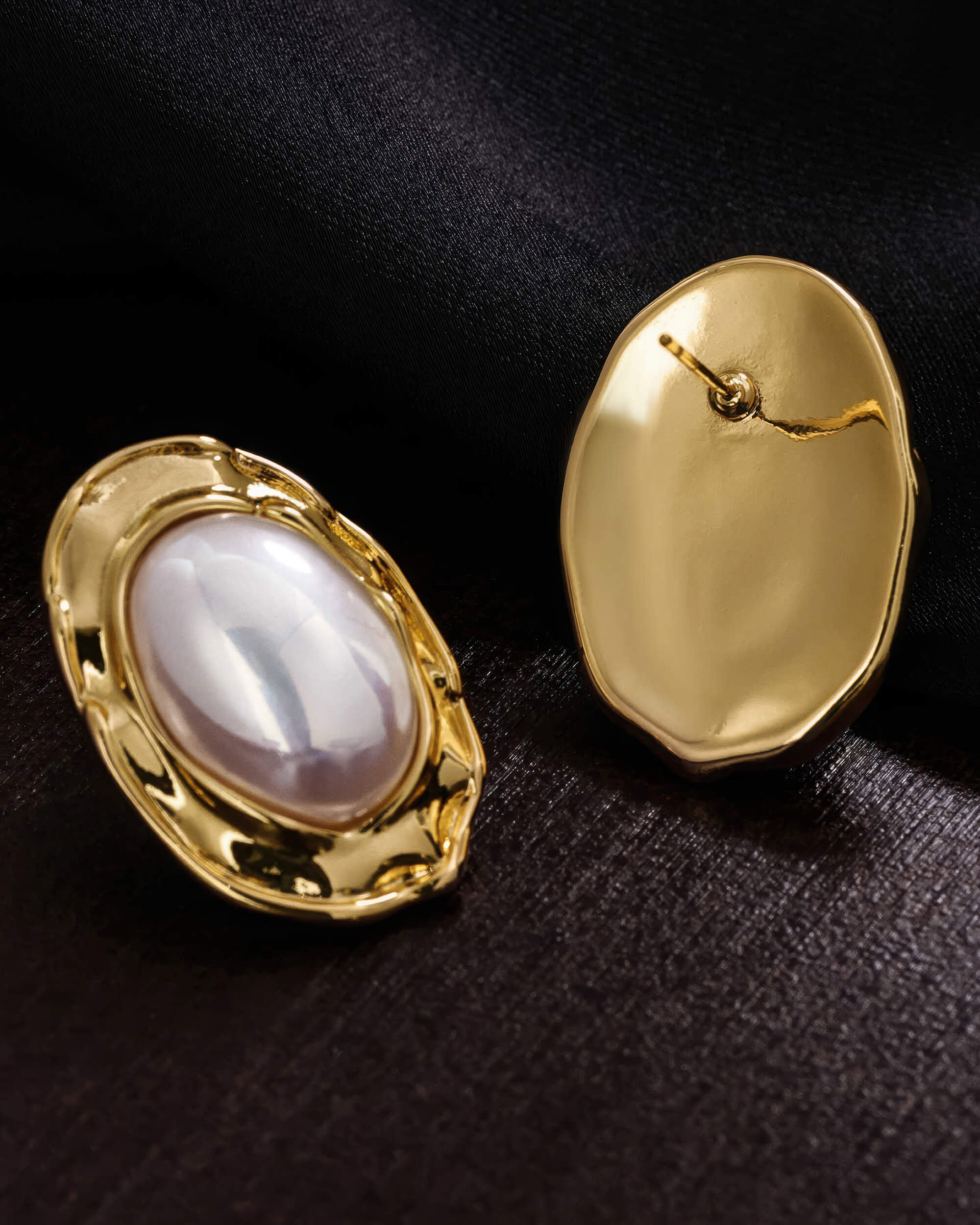 Top-down view of the gold pearl statement earrings on a minimalist background, perfect for bridal or formal wear.