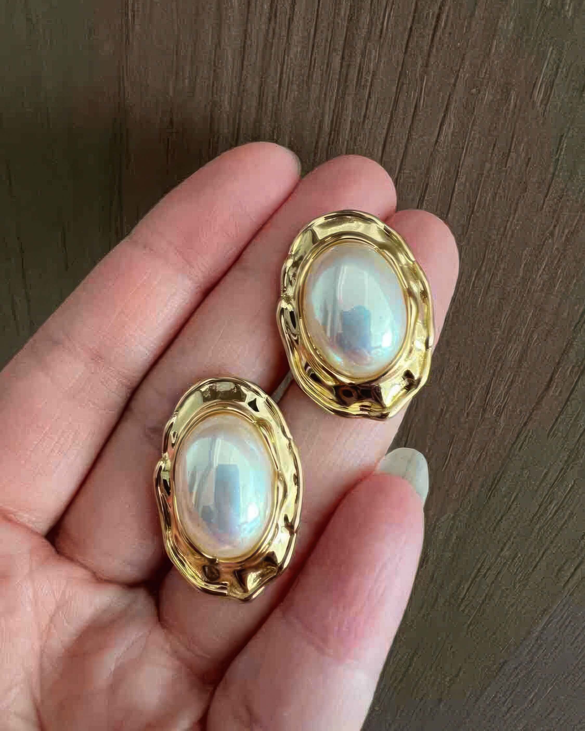Lifestyle shot of the vintage-inspired Mabe pearl earrings, styled with a pearl necklace for a complete look.