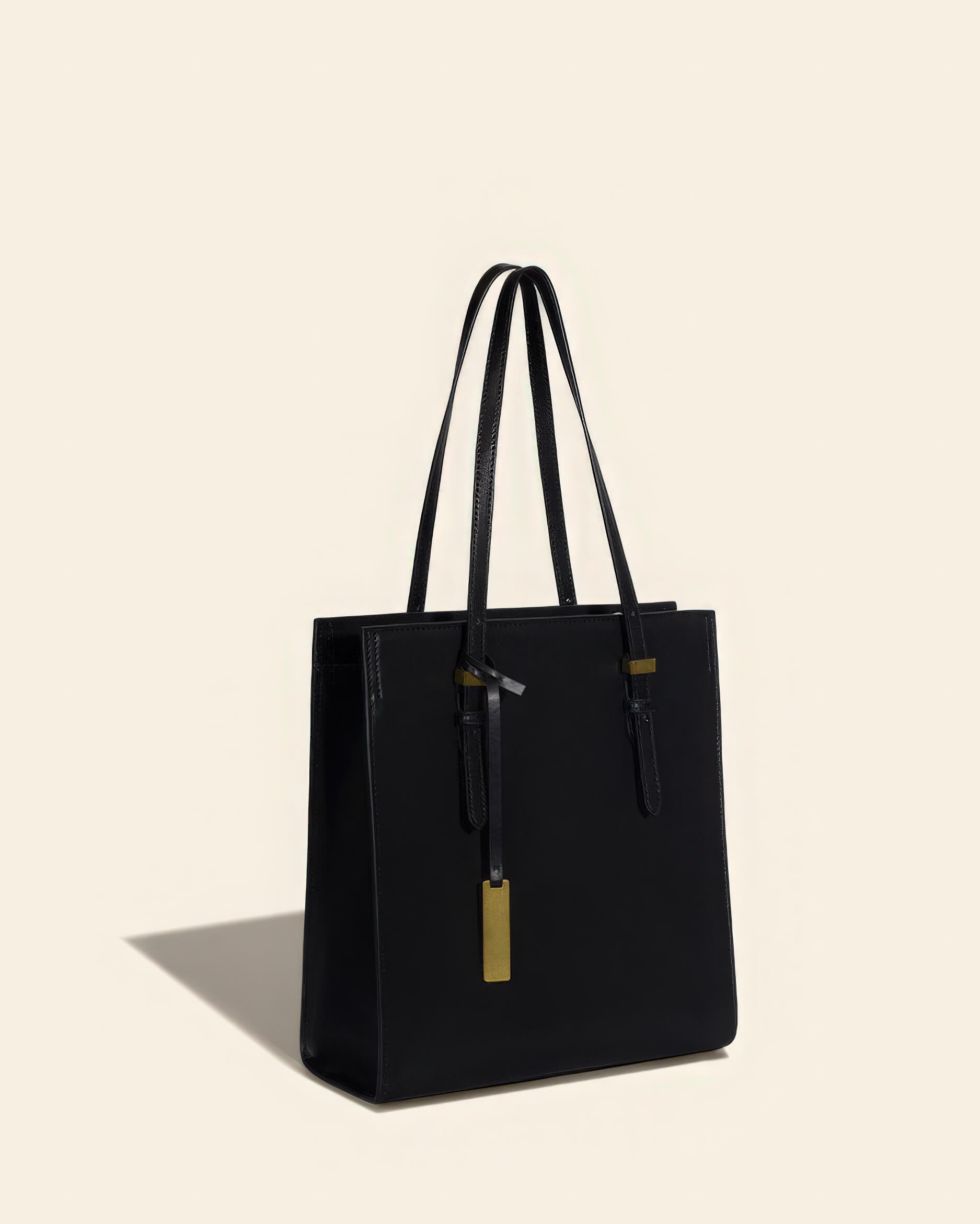 Perspective view of a black leather work tote bag standing upright on a clean background.
