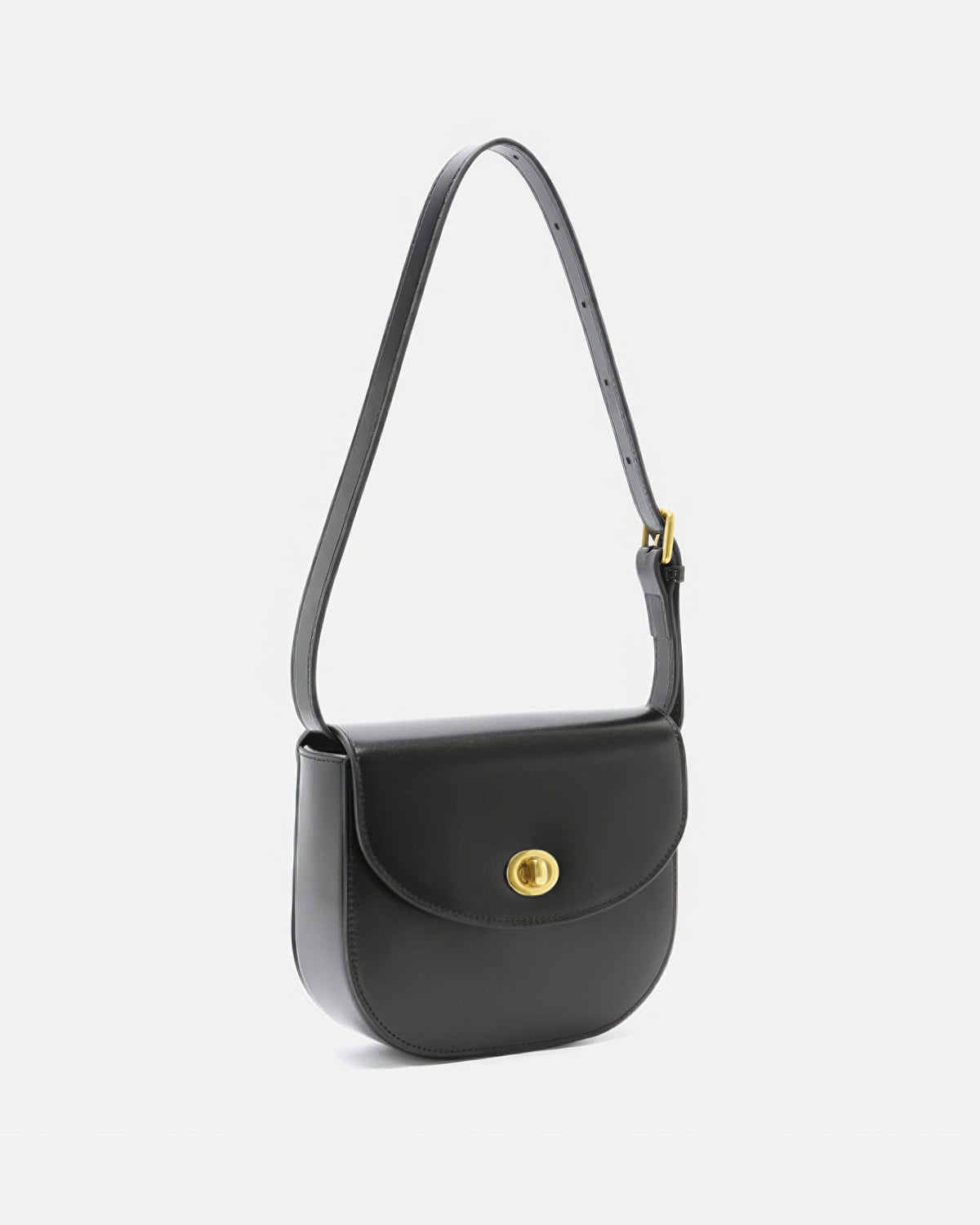 Three-quarter side view of a black leather flap saddle bag with gold turn-lock closure and adjustable strap.