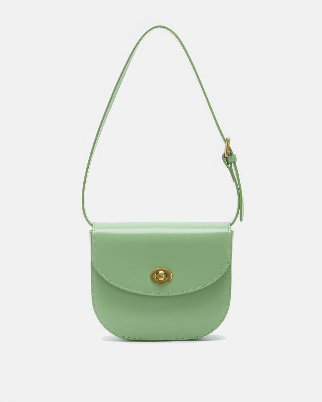 Front view of a sage green classic leather flap saddle crossbody bag with a gold turn-lock closure on a plain background.

