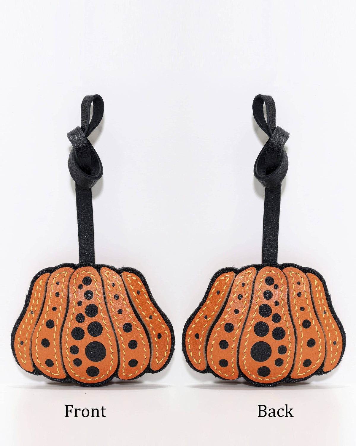 Side-by-side front and back view of orange polka dot pumpkin leather charm.