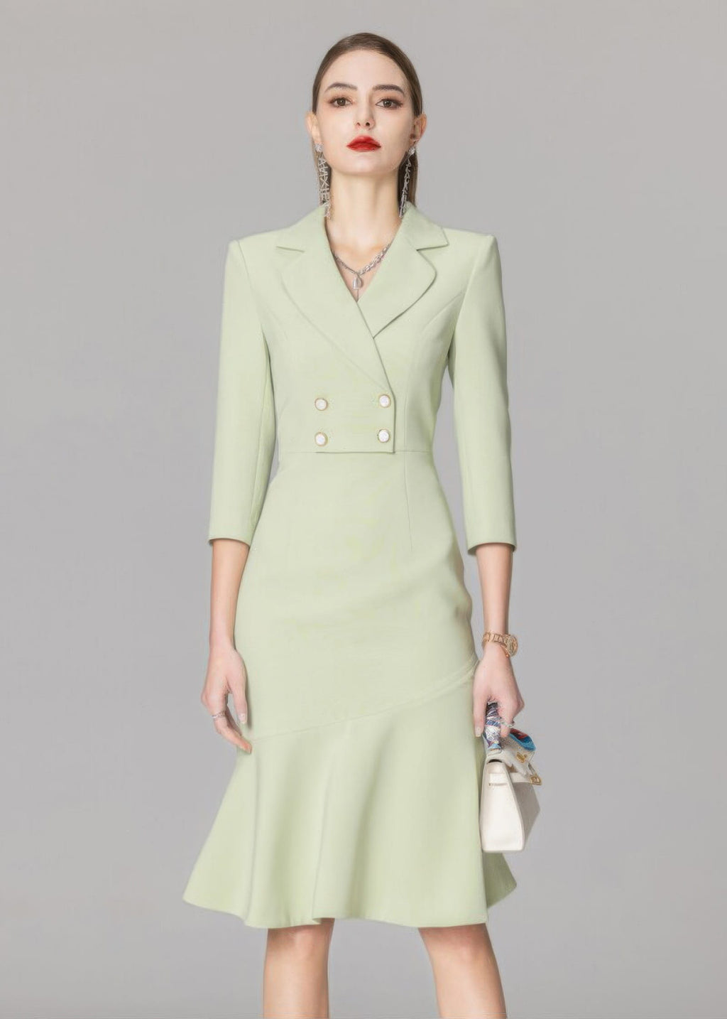A cropped front view of the light green blazer dress, focusing on the double-breasted button detail and the structured shoulders.