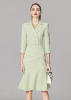 A cropped front view of the light green blazer dress, focusing on the double-breasted button detail and the structured shoulders.