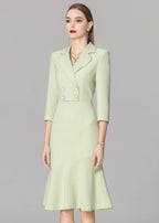 A medium shot of the model in the light green blazer dress, looking slightly to the side to showcase the profile of the collar and sleeves.