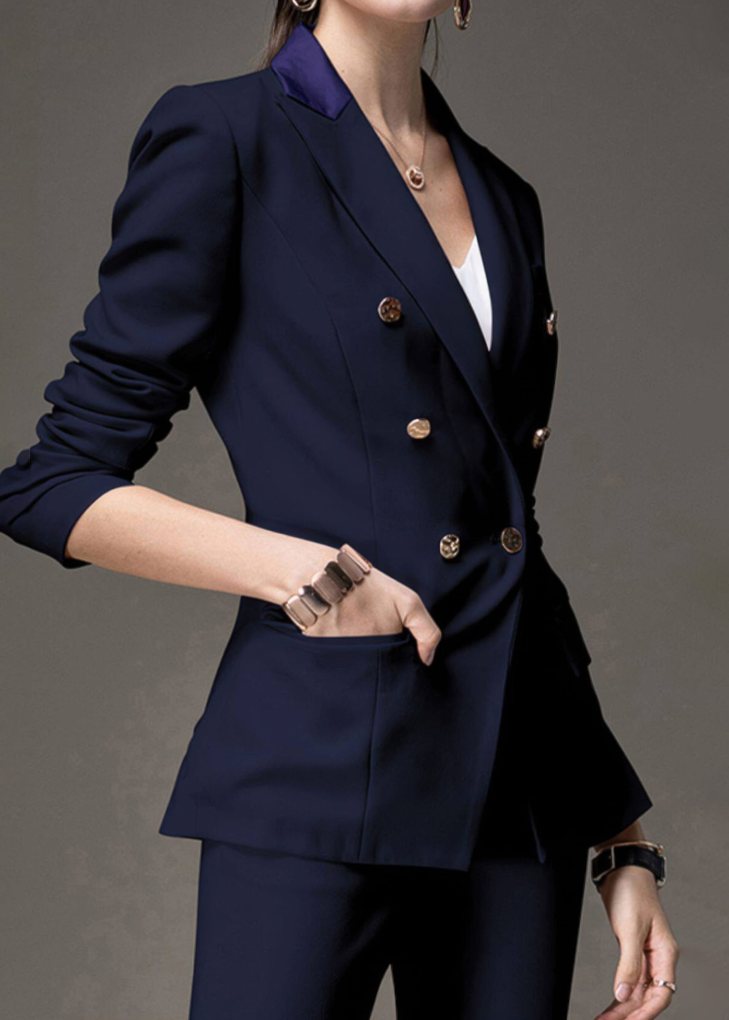 Side profile close-up of the navy blue double-breasted blazer highlighting the tailored fit and gold button details.