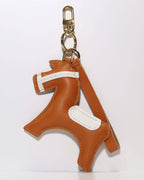 Orange leather equestrian horse keychain featuring a polished gold-tone clasp and key ring for purse accessories.