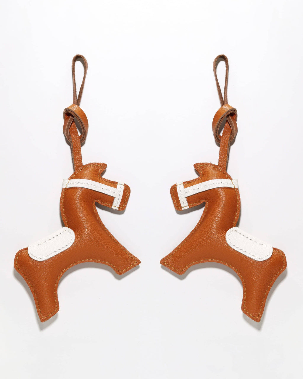 Side-by-side display of the front and back of a handcrafted French goatskin leather equestrian horse charm.