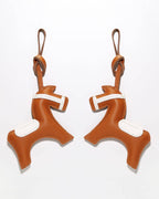 Side-by-side display of the front and back of a handcrafted French goatskin leather equestrian horse charm.