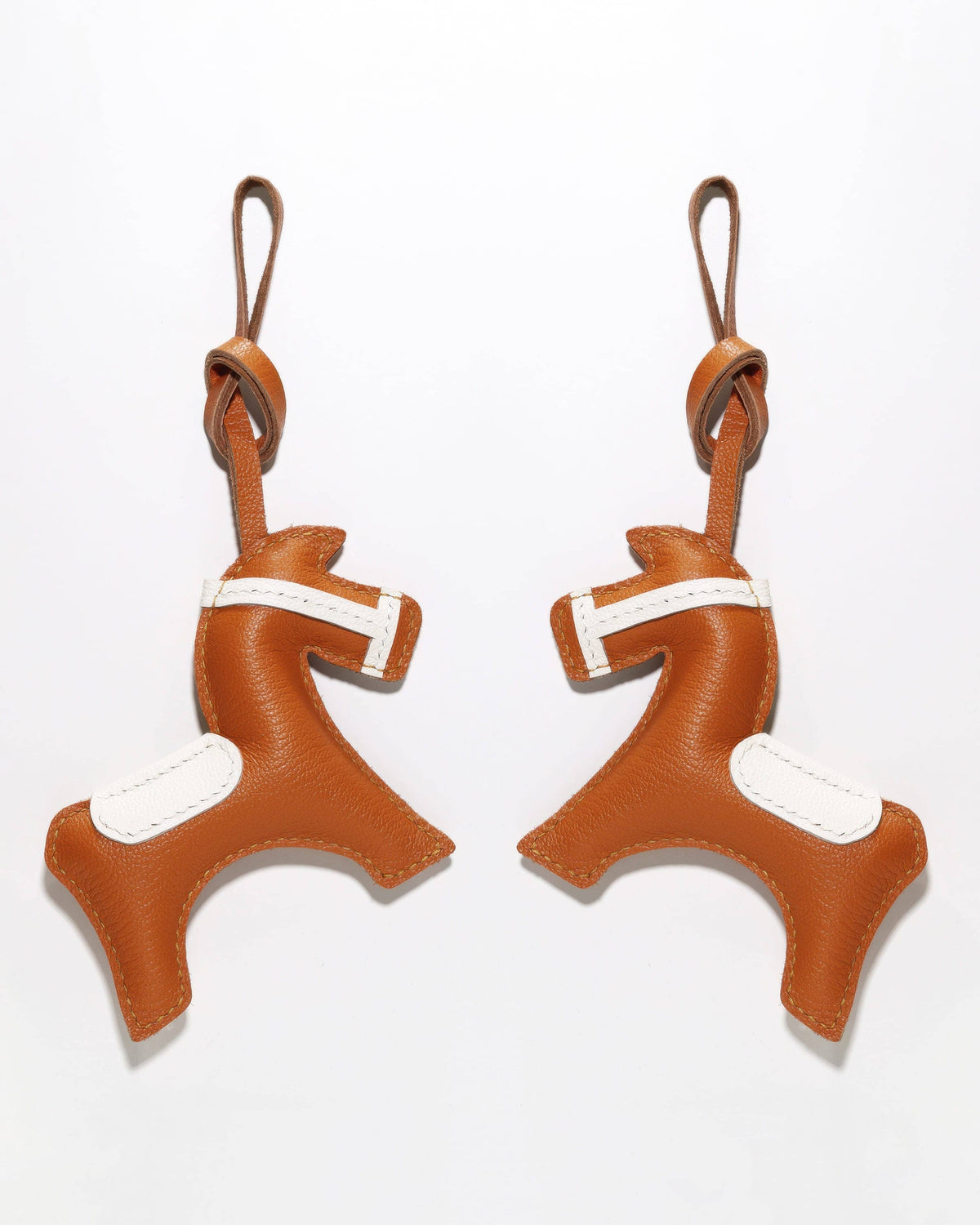 Side-by-side display of the front and back of a handcrafted French goatskin leather equestrian horse charm.