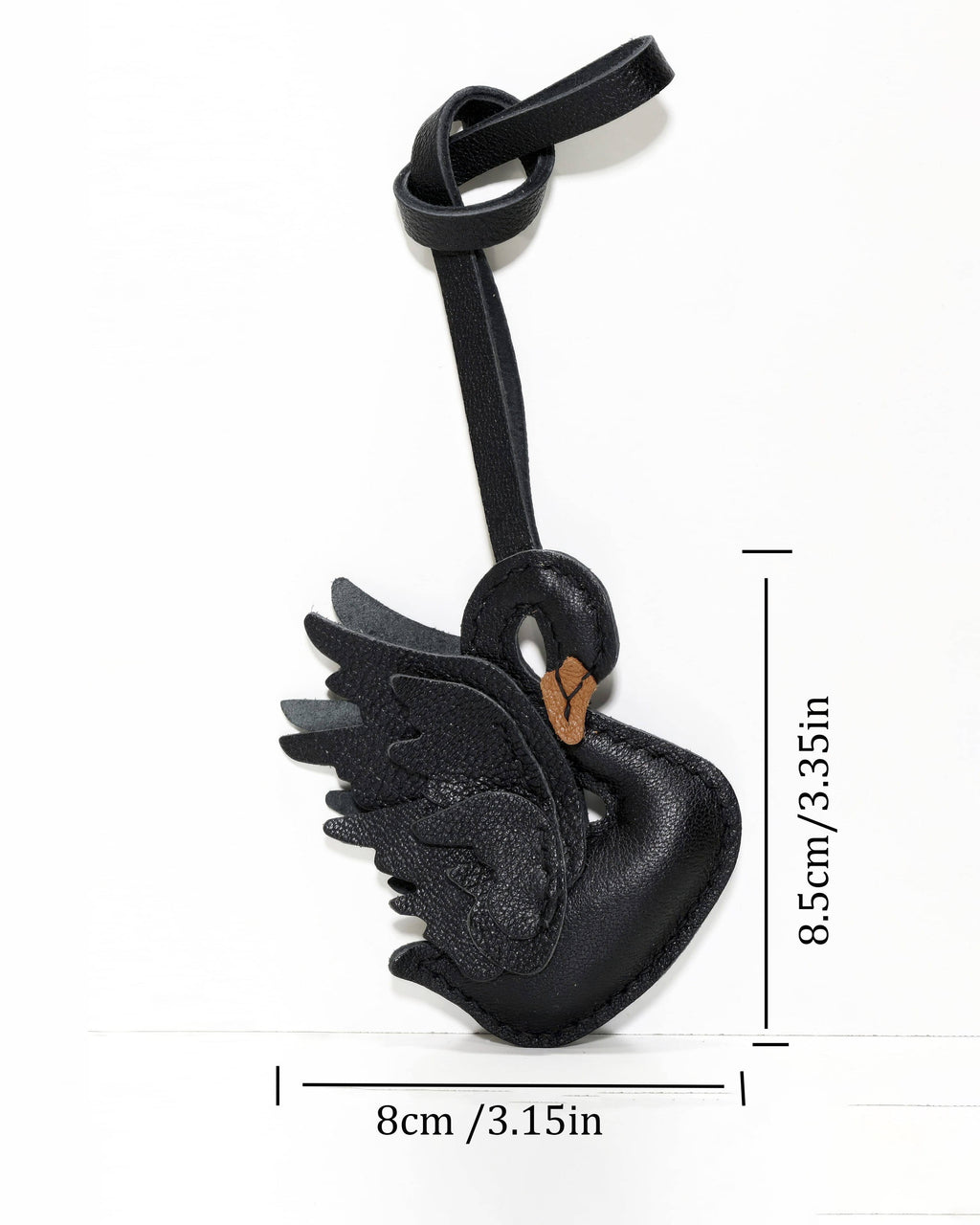 Size dimension diagram of black swan leather charm measuring 8cm width and 8.5cm height.