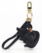 Black swan leather charm accessory with gold metal keychain hardware.