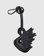 Back view of handcrafted black swan leather charm showing detailed wing stitching.