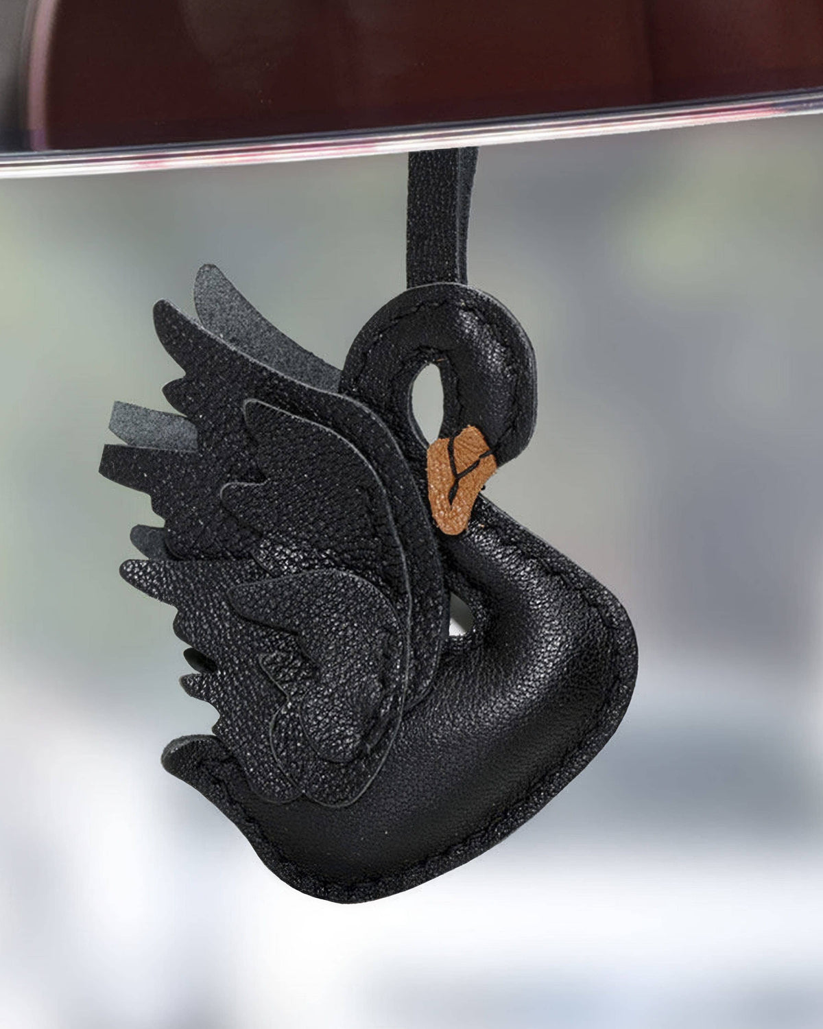 Black swan leather charm hanging as a car mirror accessory or bag charm.