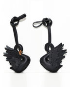 Side-by-side front and back view of black swan leather bag charm.