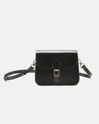Studio product shot of a black leather flap crossbody bag with a gold buckle closure on a plain background.