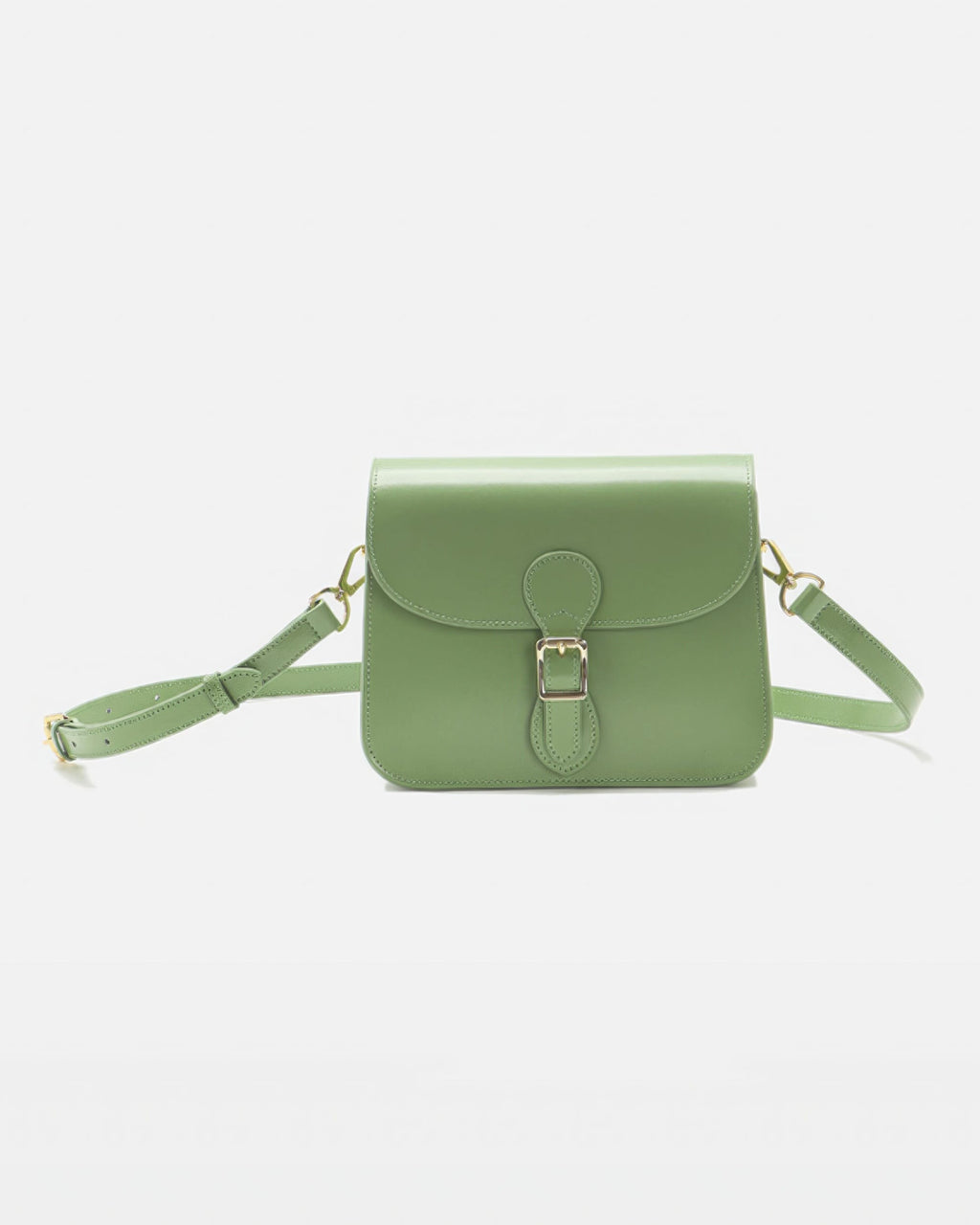 Front product view of a sage green leather flap crossbody bag with a gold buckle closure and matching shoulder strap.