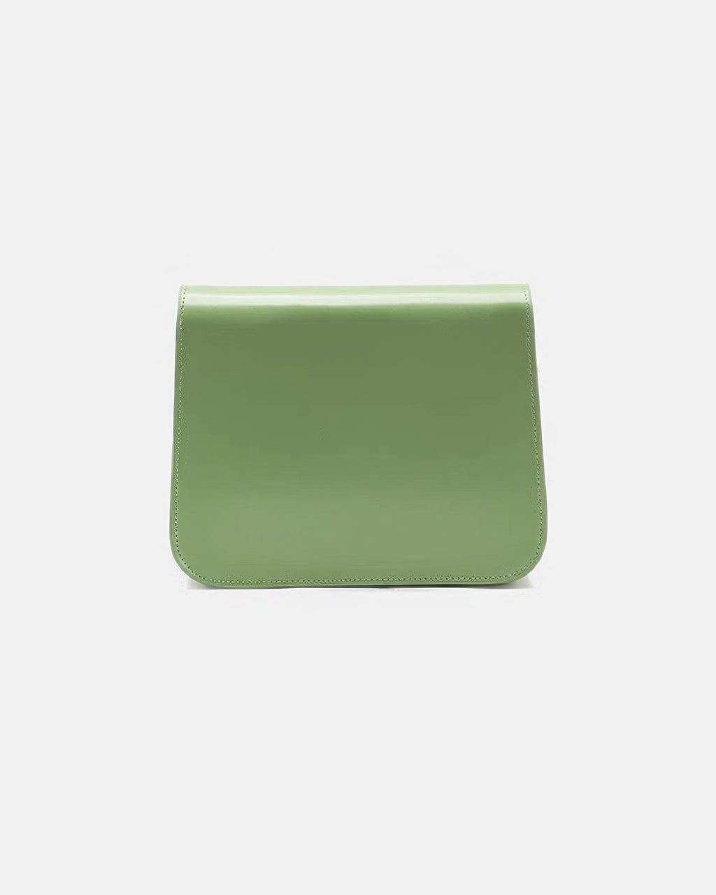 Back view of a sage green leather flap crossbody bag showcasing smooth leather texture and stitching detail.