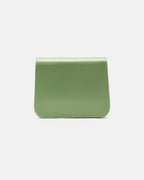 Back view of a sage green leather flap crossbody bag showcasing smooth leather texture and stitching detail.