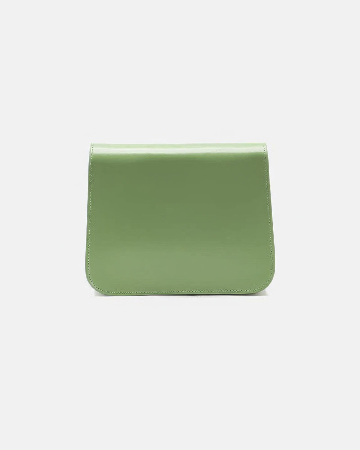 Back view of a sage green leather flap crossbody bag showcasing smooth leather texture and stitching detail.