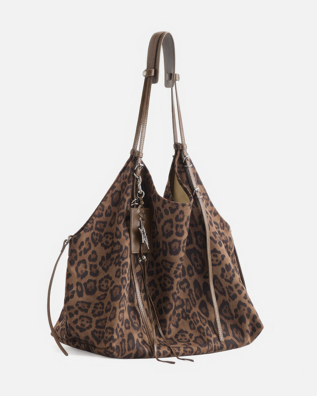 Angled side view of large brown leopard print suede hobo bag with long hanging leather straps and silver star charm