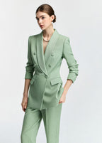 A medium shot from a slight angle, highlighting the textured fabric of the blazer and the model's sophisticated styling.