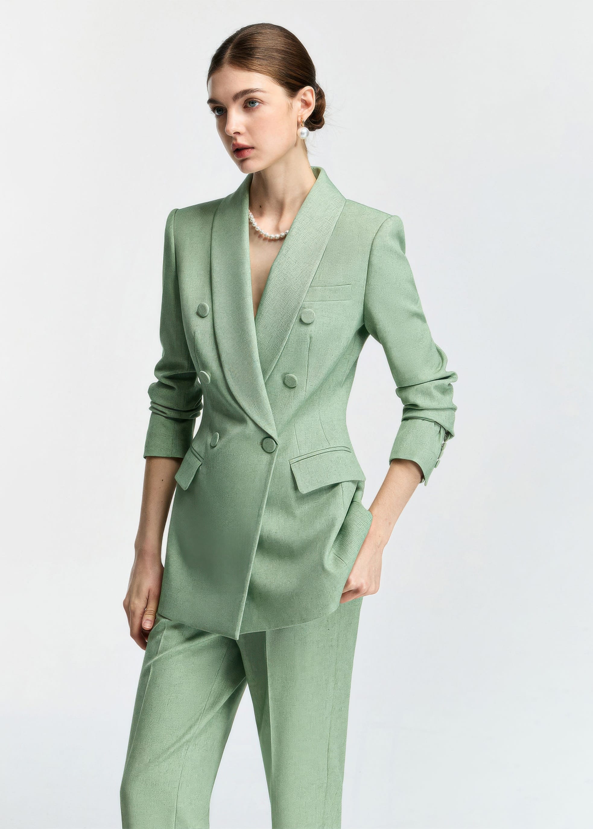 A medium shot from a slight angle, highlighting the textured fabric of the blazer and the model's sophisticated styling.
