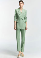 A full-length studio shot of the model in a neutral pose, displaying the complete mint green slim-fit ensemble against a white background.
