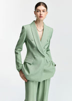 A close-up shot of the blazer, showing the double-breasted buttons, lapels, and pocket flaps in detail.