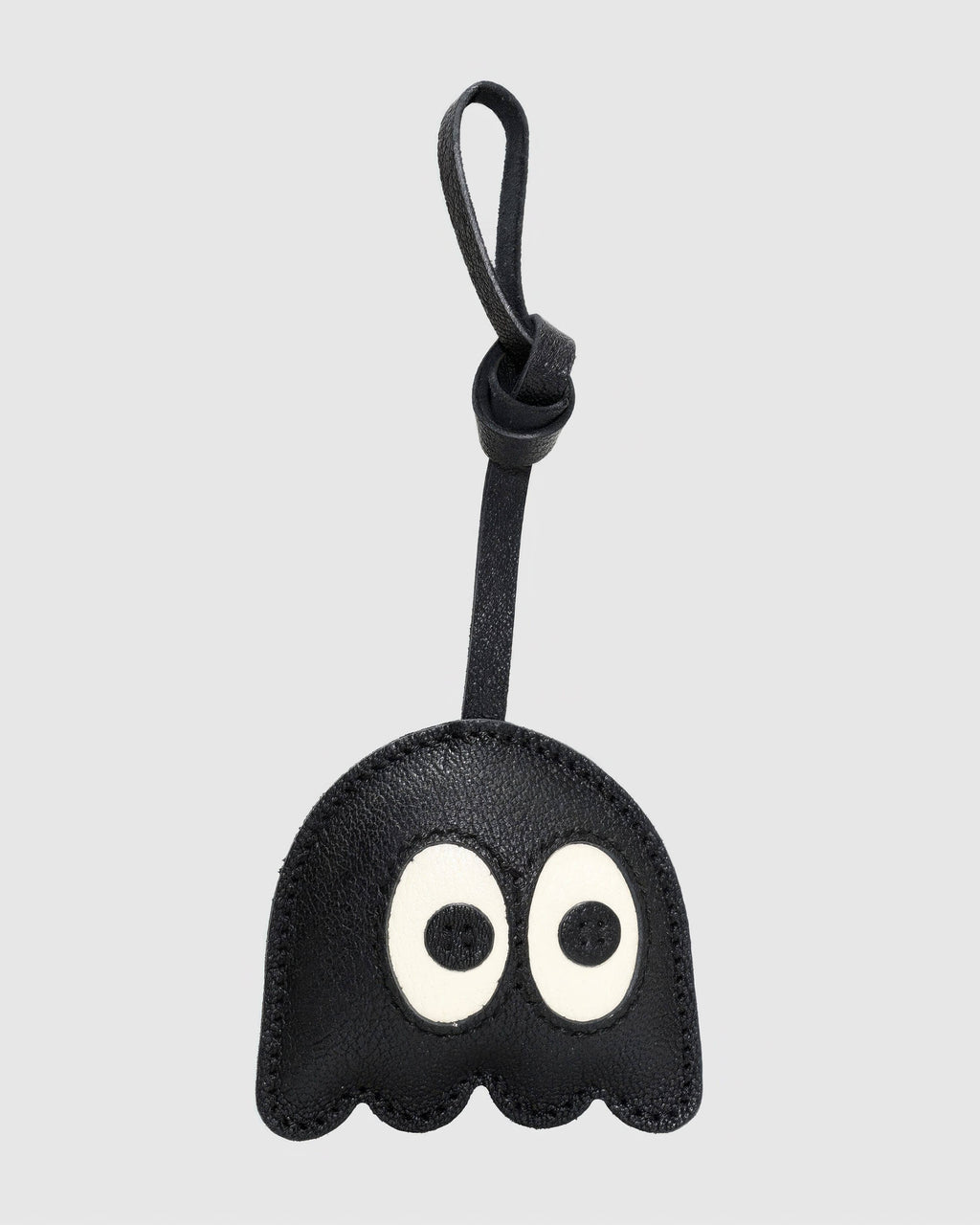 Front view of playful black ghost bag charm made of French goatskin leather with knot strap.