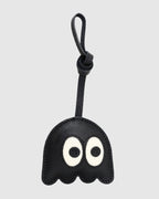 Front view of playful black ghost bag charm made of French goatskin leather with knot strap.