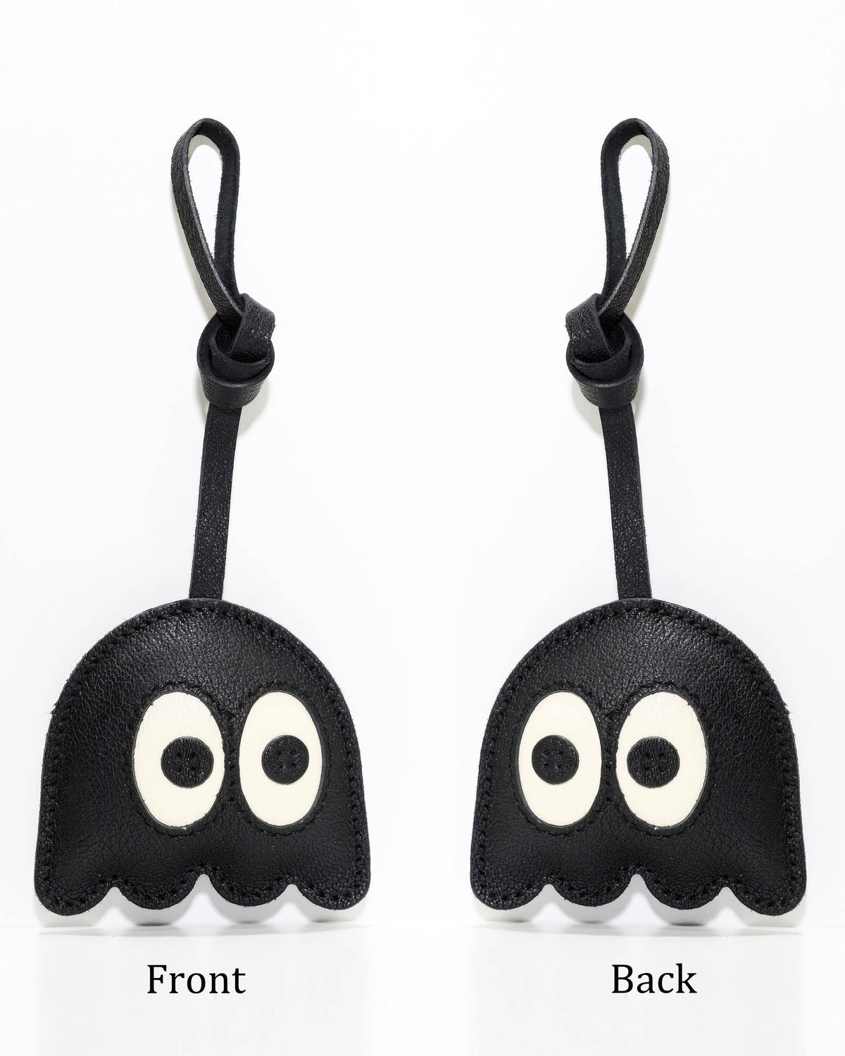 Front and back view comparison of black ghost leather bag charm accessory.
