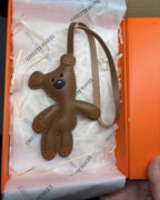 Brown handcrafted French goatskin leather teddy bear bag charm neatly packaged in an luxury orange gift box with logo tissue paper.