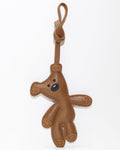 Front view of a brown playful teddy bear bag charm made of genuine French goatskin leather with a knotted hanging loop.