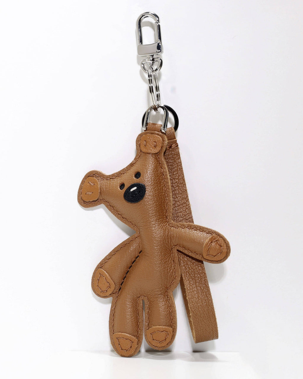 Brown leather teddy bear bag charm featuring a silver metal clasp attachment for handbag styling.