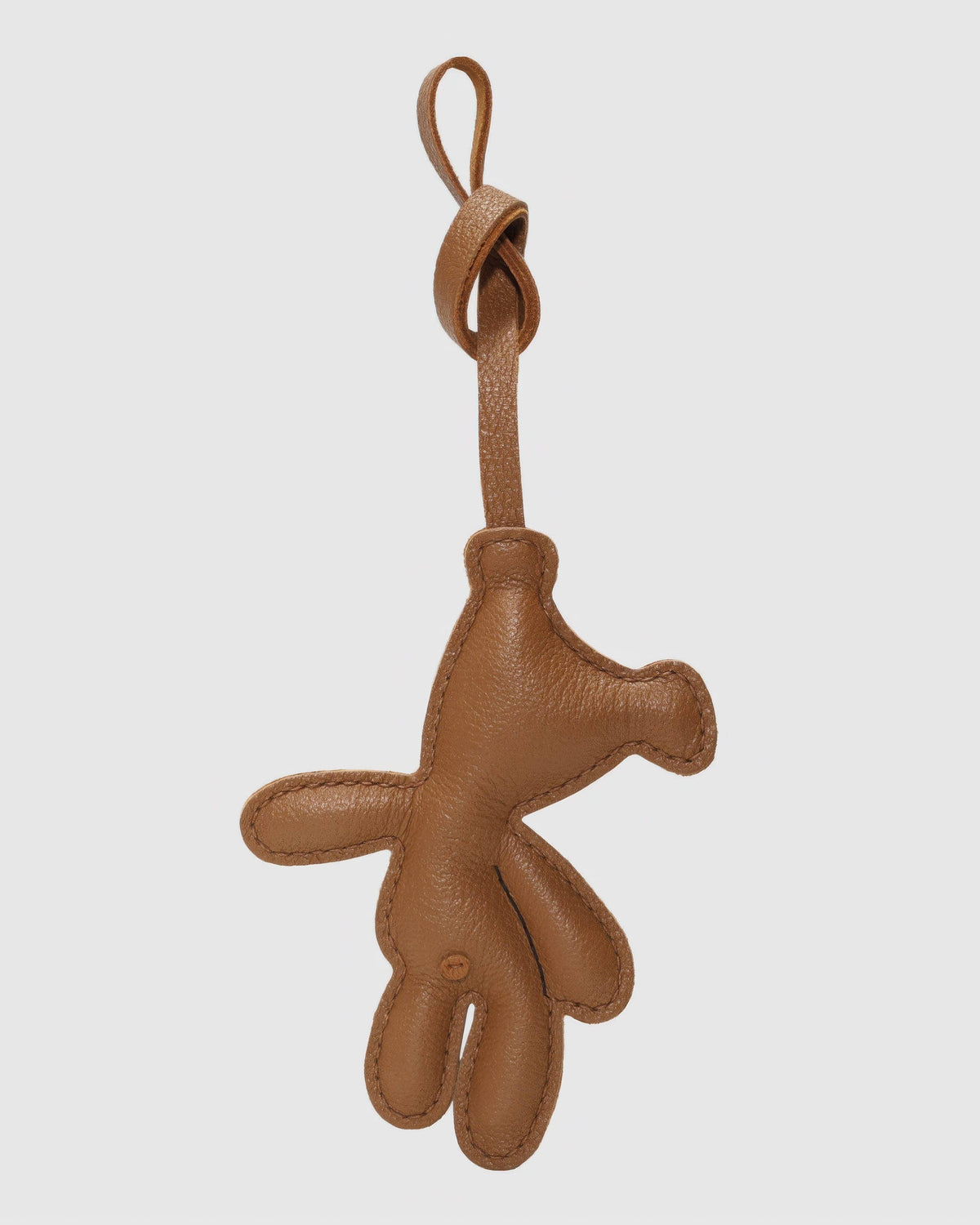 Back view of a brown leather teddy bear bag charm showing smooth back stitching and goatskin leather texture.