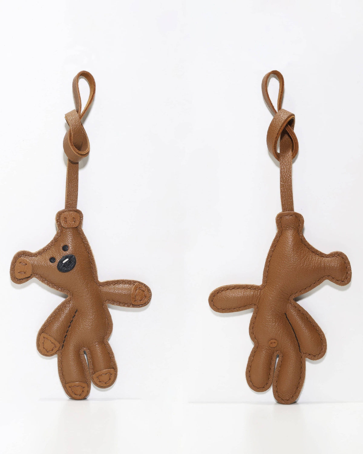 Front and back views of a brown handcrafted French goatskin leather teddy bear bag charm side by side.