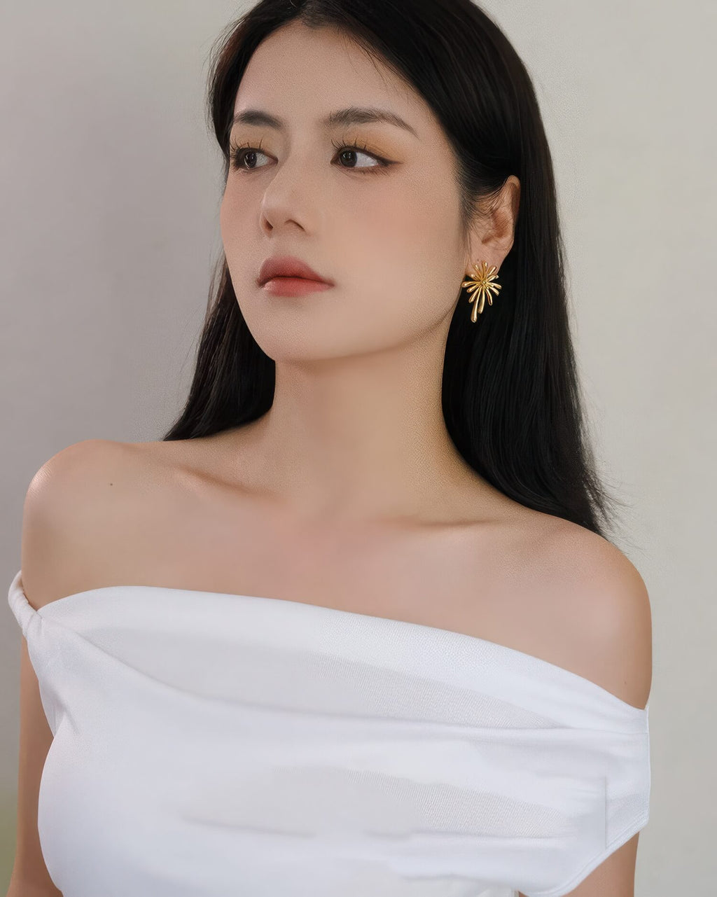 Elegant model wearing the oversized 18K gold plated burst stud earrings for a sophisticated evening look.