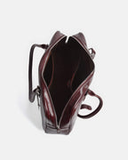 Top view of open burgundy vintage Boston bag showing spacious interior compartments.