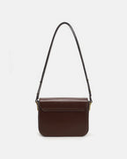 Back view of a smooth brown leather flap shoulder bag on a plain white studio background.