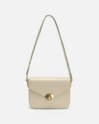 Off-white minimalist leather flap crossbody handbag with gold hardware against a clean white background.