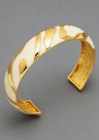 A high-angle close-up of the cream and gold Vintage Zebra Stripe Enamel Cuff Bracelet, showcasing the intricate gold-textured interior and smooth, wavy enamel pattern.
