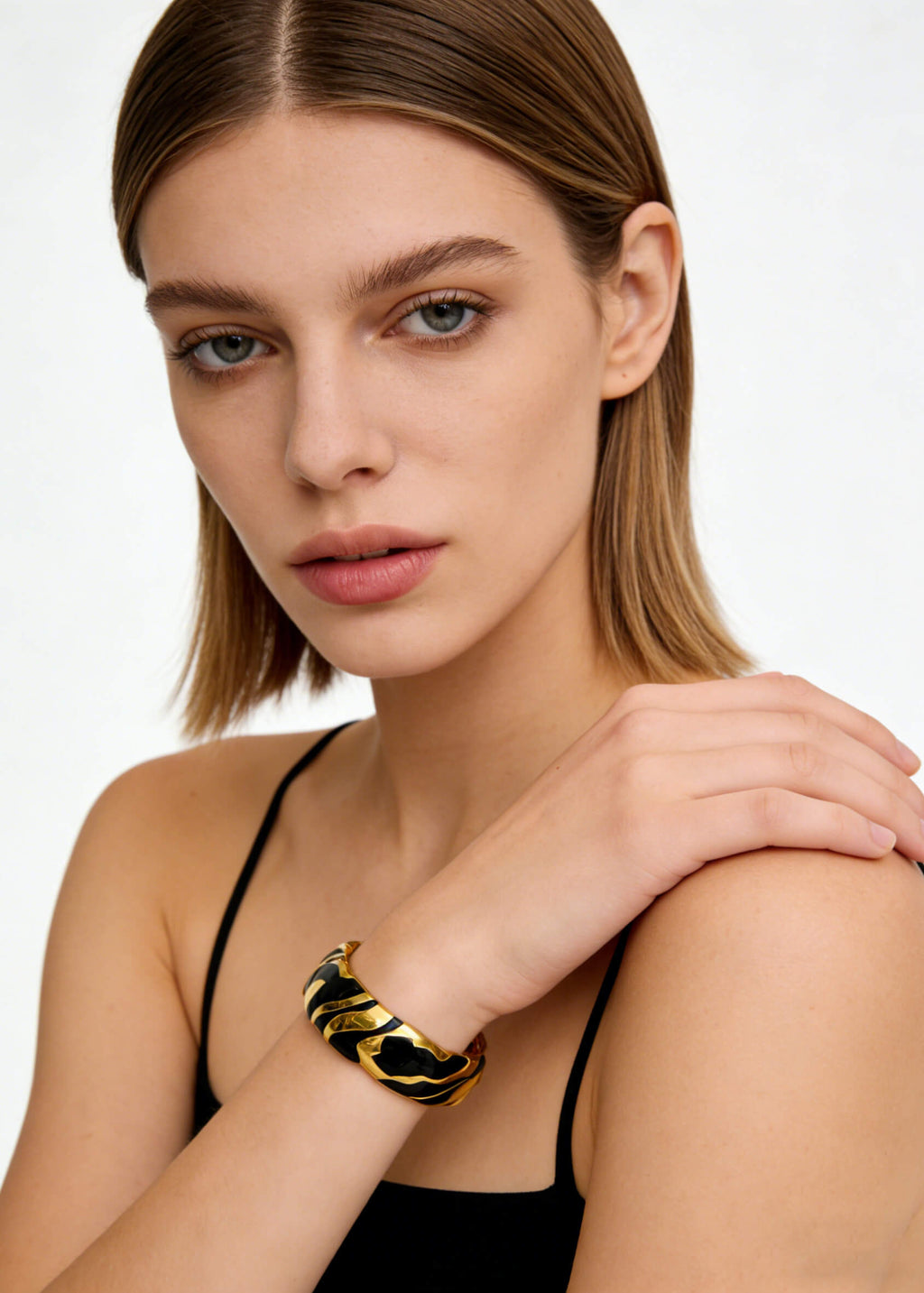 Model showcasing the statement Vintage Zebra Stripe Enamel Cuff Bracelet, emphasizing its size and bold gold accents.