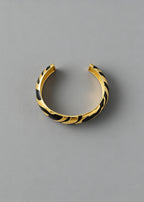 Overhead view of the black and gold Vintage Zebra Stripe Enamel Cuff Bracelet showing the open-back adjustable cuff style.