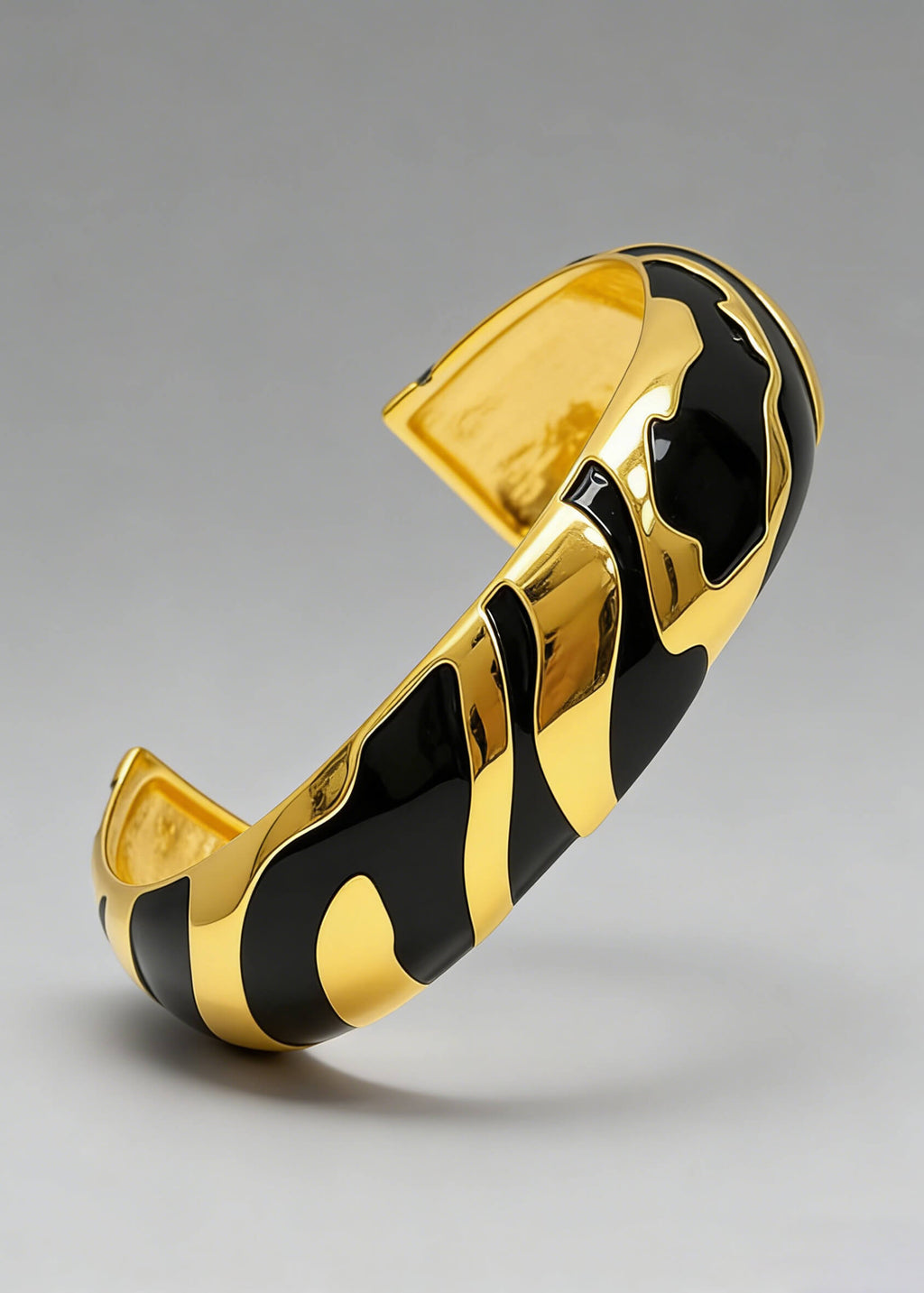 High-angle detail of the black enamel and gold-plated Vintage Zebra Stripe Enamel Cuff Bracelet.