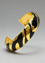 High-angle detail of the black enamel and gold-plated Vintage Zebra Stripe Enamel Cuff Bracelet.