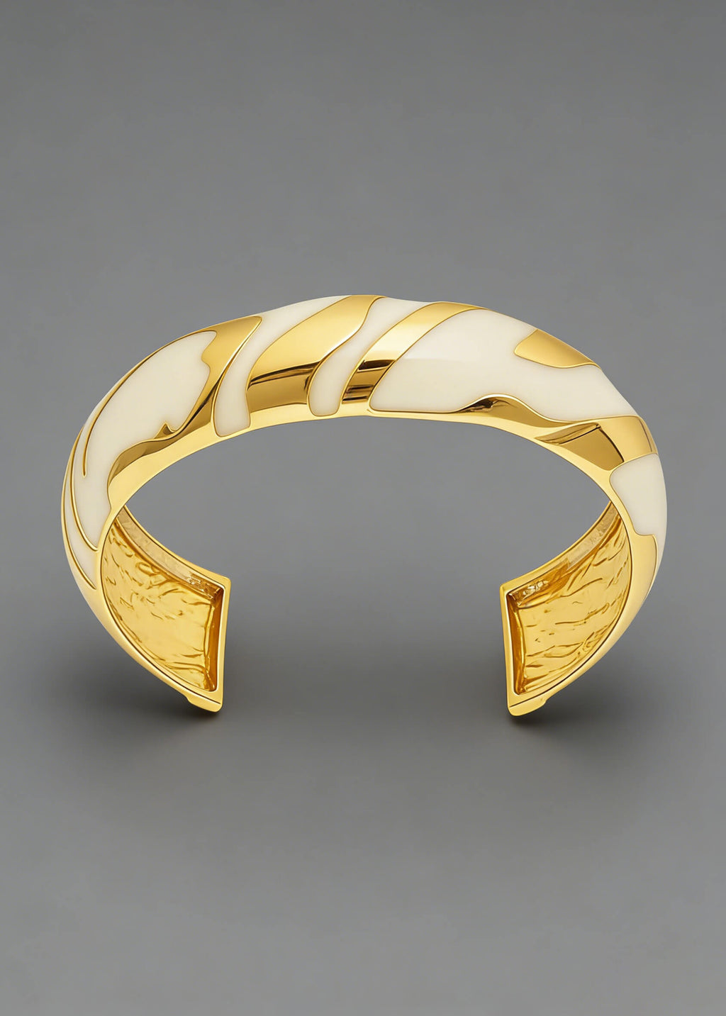 Front-facing view of the cream and gold Vintage Zebra Stripe Enamel Cuff Bracelet against a gray background.